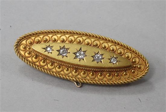 A Victorian oval yellow metal brooch set with five old-cut diamonds